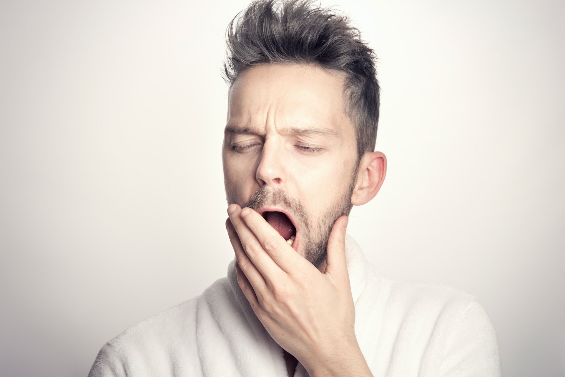 A man yawning widely after getting a deep sleep