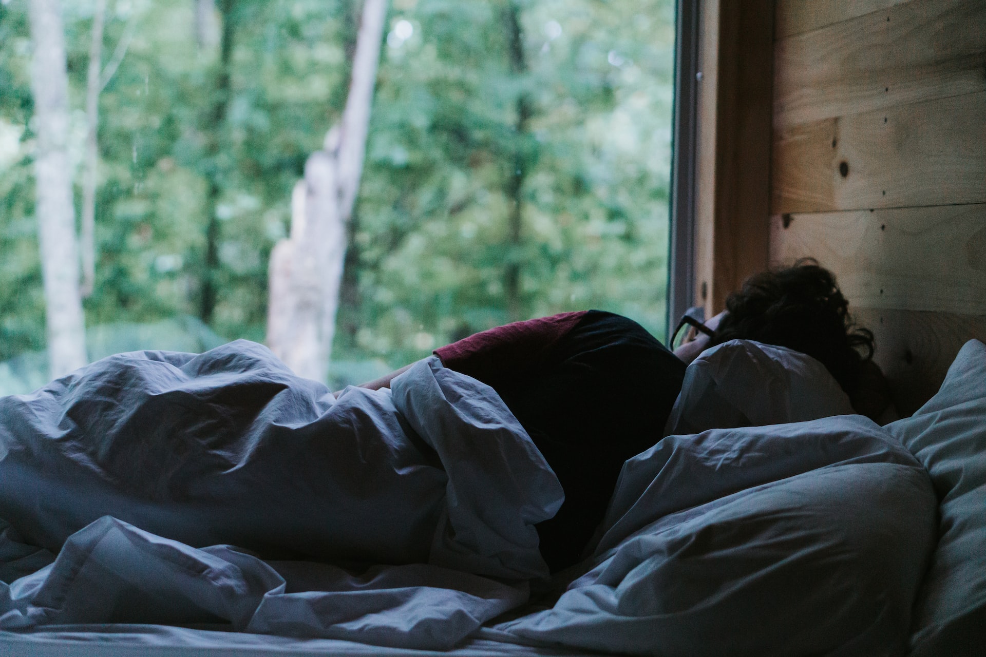 A women sleeping by a window taking her sleep pattern seriously