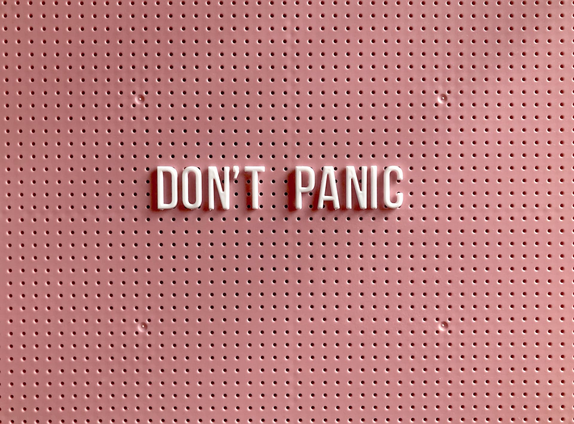 Don't Panic on a pink background