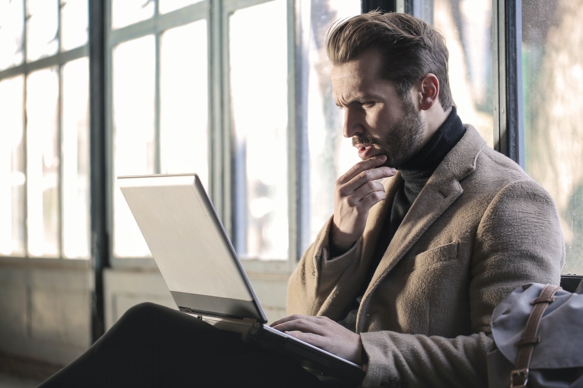 A man on his laptop searching if brain relaxation techniques are safe