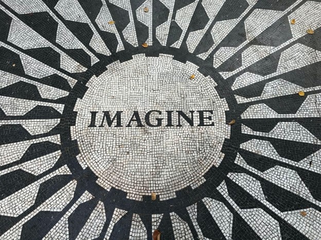 the word imagine in black and white mosaic tiling