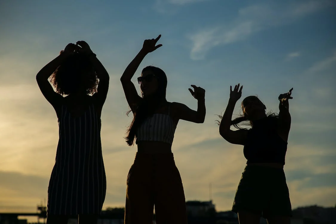 Three Women Dancing With A Positive Mindset Approaching Addiction Recovery
