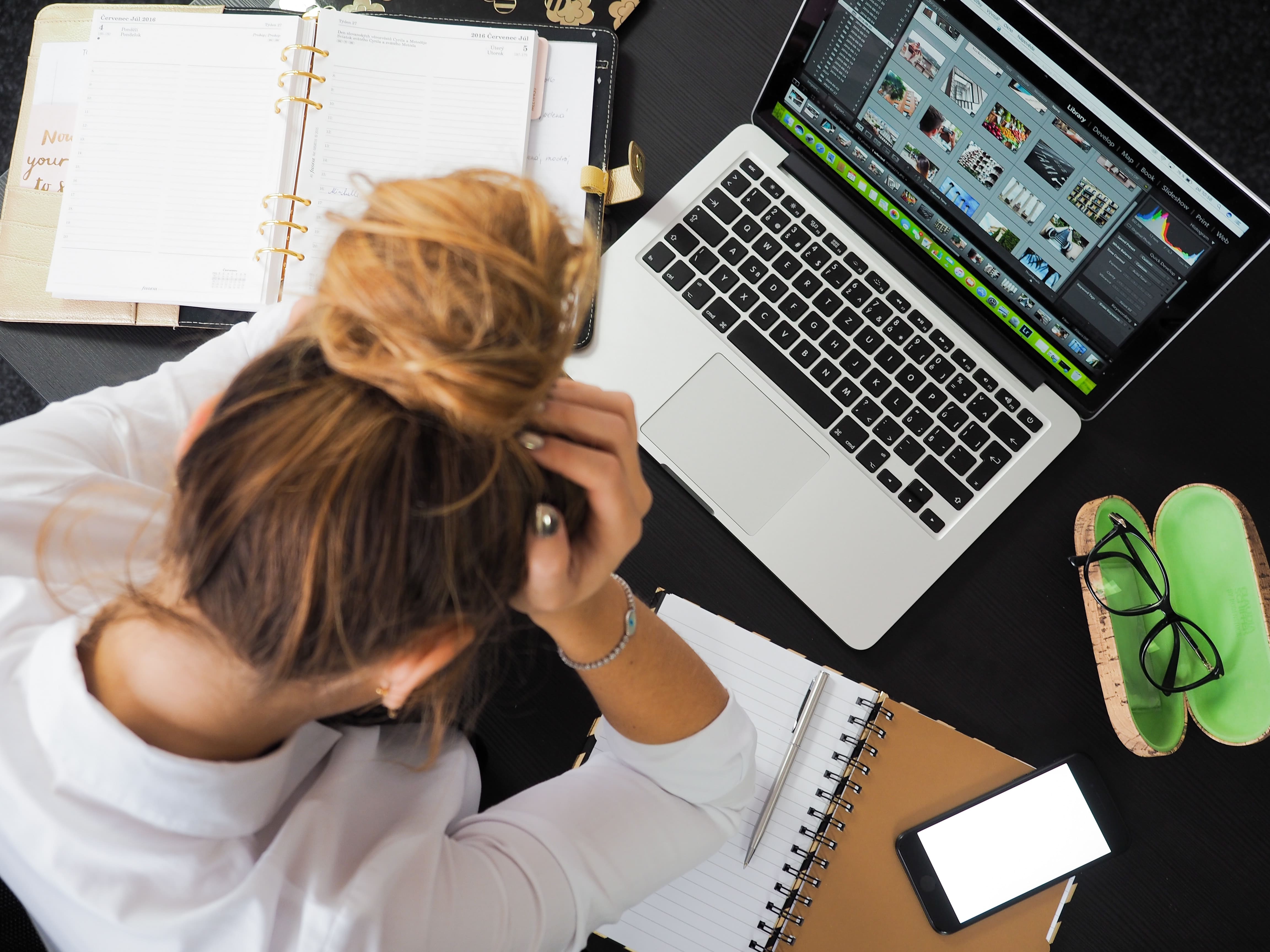 A woman looking very stressed with work and life who would greatly benefit from trying neuro-relaxation.