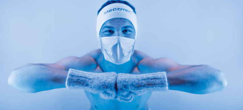 A happy individual smiling in anticipation before a whole body cryotherapy session.