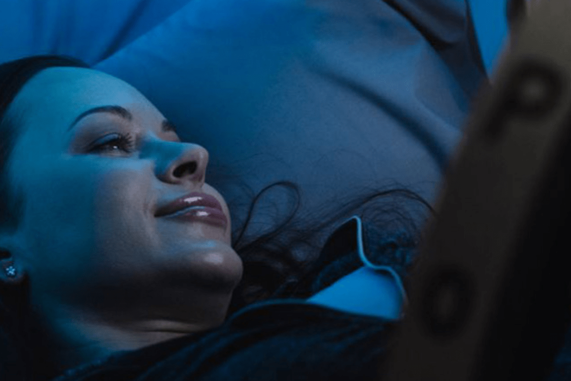 A woman relaxes inside a hyperbaric oxygen therapy chamber, a treatment associated with the foundational principles of mild hyperbaric oxygen therapy (mHBOT) for enhanced recovery and wellness.