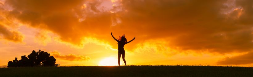 A silhouette of a women jumping for joy from the benefits of pneumatic compression therapy