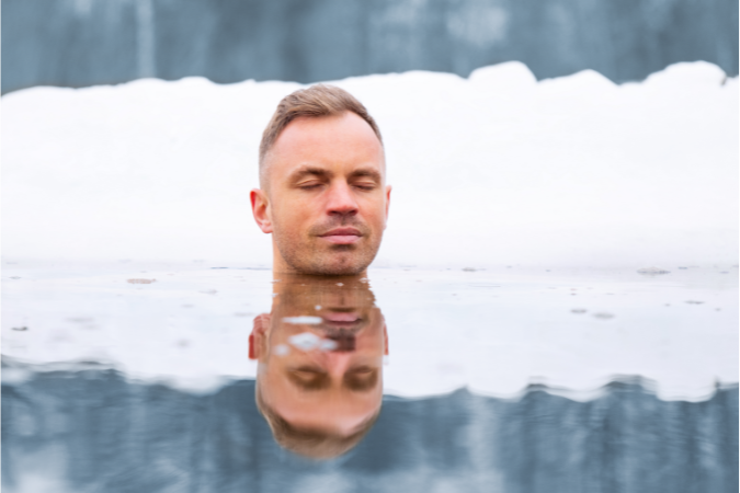 Man meditating in ice water to show the benefits of having an ice bath