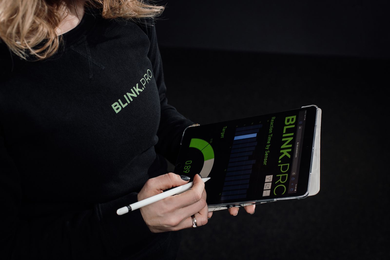 A personal trainer setting up a blink pro ready for use in her gym